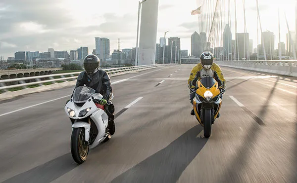 Metric Motorcycle Riding Over Highway Bridge